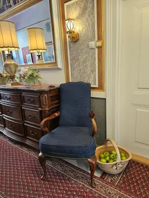 a chair in a room with a mirror and a basket of apples at VANSVEL Boutique Apartment 14 in Belgrade