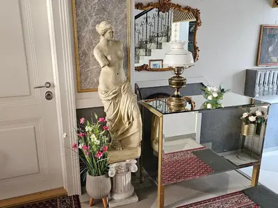 a statue of a woman standing next to a desk at VANSVEL Boutique Apartment 14 in Belgrade