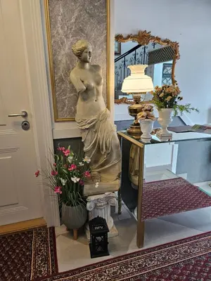 a statue of a woman sitting next to a table at VANSVEL Boutique Apartment 14 in Belgrade
