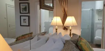 a living room with two lamps and a mirror at VANSVEL Boutique Apartment 14 in Belgrade