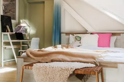 a bedroom with a large bed and a desk at Pintrst-Penthouse 110m2 Ping Pong Old Town in Belgrade