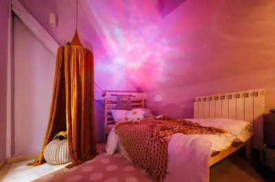 a bedroom with a pink and purple ceiling at Pintrst-Penthouse 110m2 Ping Pong Old Town in Belgrade