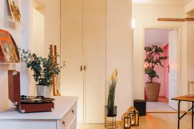 a living room with a door and some plants at Pintrst-Penthouse 110m2 Ping Pong Old Town in Belgrade