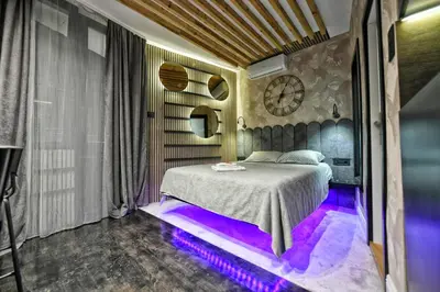 a bedroom with a bed with purple lights on the floor at Dorcol Downtown Studio in Belgrade