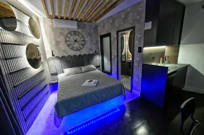 a bedroom with a bed and a sink and a clock at Dorcol Downtown Studio in Belgrade
