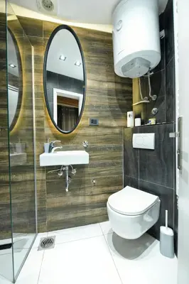 a bathroom with a toilet and a mirror at Dorcol Downtown Studio in Belgrade