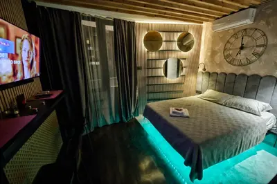 a bedroom with a bed and a clock on the wall at Dorcol Downtown Studio in Belgrade