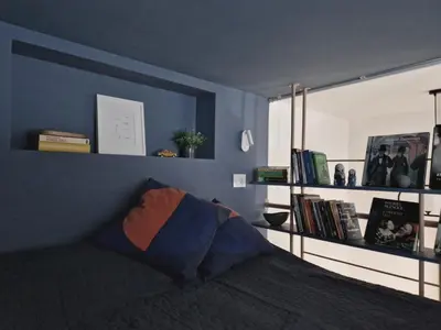 a bedroom with a bed and a shelf with books at Studio MAXIM in Vračar (historical)
