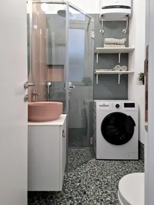 a bathroom with a washing machine and a shower at Studio MAXIM in Vračar (historical)