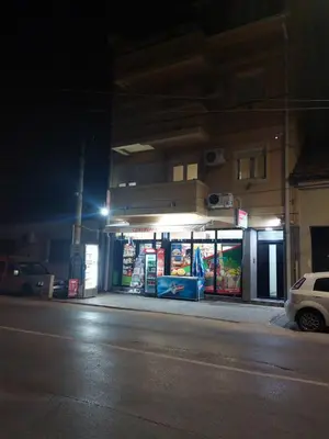 a gas station on the side of a street at night at Centro apartman 2 in Pančevo