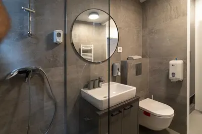 a bathroom with a sink and a mirror at REAL Suites in Ledine