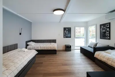 a room with two beds and a couch at REAL Suites in Ledine