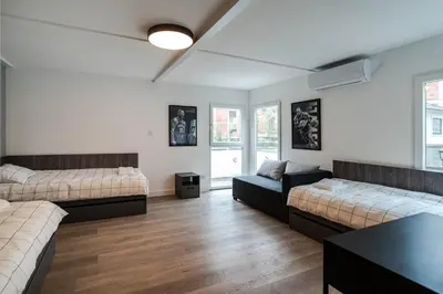 a living room with two beds and a table at REAL Suites in Ledine
