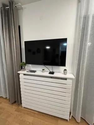 a white dresser with a flat screen tv on top at Studio 54 in Belgrade