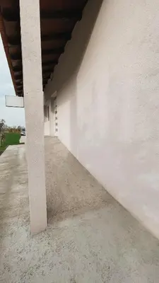 a white building with a concrete pillar in front of it at Prenoćište Katarina JUGOVO in Smederevo