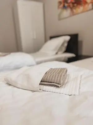 a row of white pillows sitting on a bed at Prenoćište Katarina JUGOVO in Smederevo