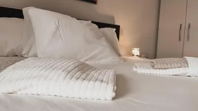 a white bed with two pillows on it at Prenoćište Katarina JUGOVO in Smederevo