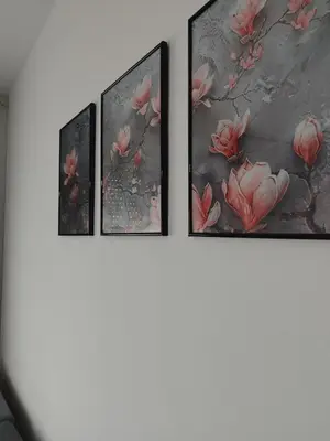 four paintings of pink flowers on a wall at Studio29 2 in Ruma