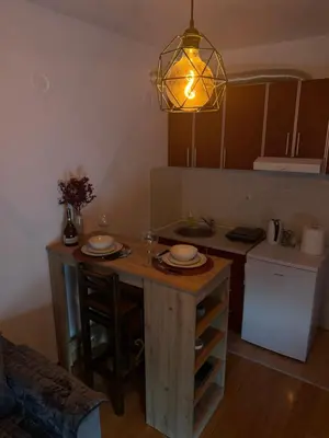 a kitchen with a table with two plates on it at Studio29 2 in Ruma