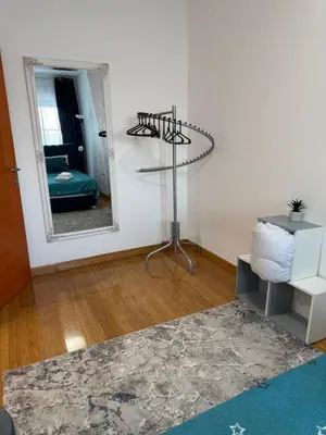 a living room with a mirror and a table at Studio29 2 in Ruma