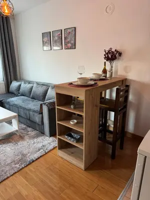 a living room with a table and a couch at Studio29 2 in Ruma