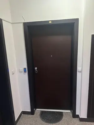 a black door in a room with white walls at xenija in Belgrade