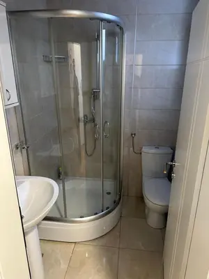 a bathroom with a shower and a toilet and a sink at xenija in Belgrade