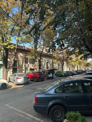 a parking lot with cars parked in front of a building at xenija in Belgrade