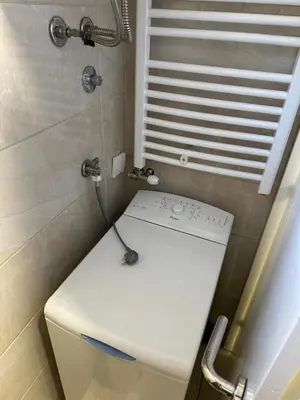 a small bathroom with a toilet and a window at xenija in Belgrade