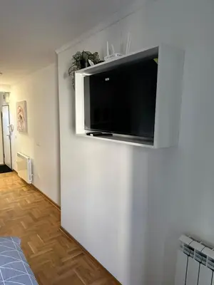 a living room with a flat screen tv on a wall at xenija in Belgrade