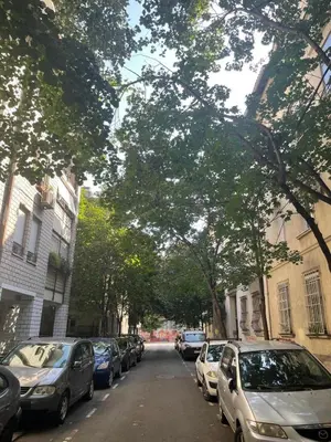 a street with cars parked on the side of the road at M&O Belgrade in Belgrade