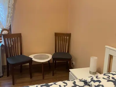 a bedroom with two chairs and a table and a bed at M&O Belgrade in Belgrade
