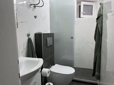 a bathroom with a toilet and a sink and a shower at M&O Belgrade in Belgrade