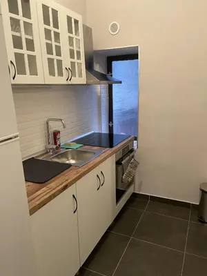 a kitchen with white cabinets and a sink at M&O Belgrade in Belgrade