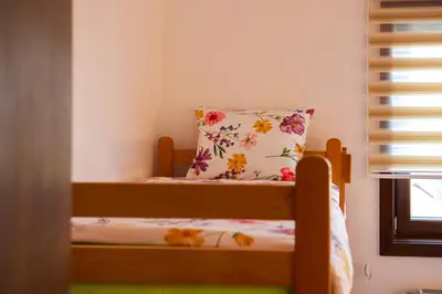 a small bedroom with a bed with a pillow on it at NaFiJa Apartman in Smederevo