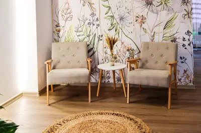 two chairs and a table in a room with a wallpaper at NaFiJa Apartman in Smederevo