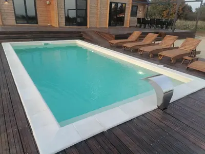 a swimming pool with chairs and a deck at Casa del Corniolo Spa and Pool House Fruška gora in Čortanovci
