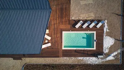 an overhead view of a swimming pool on a wooden floor at Casa del Corniolo Spa and Pool House Fruška gora in Čortanovci