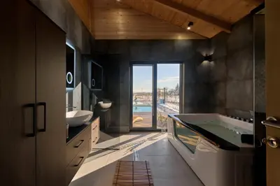 a bathroom with a large tub and a large window at Casa del Corniolo Spa and Pool House Fruška gora in Čortanovci
