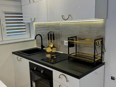 a kitchen with a sink and a counter top at Apartman City Zeleznik in Belgrade