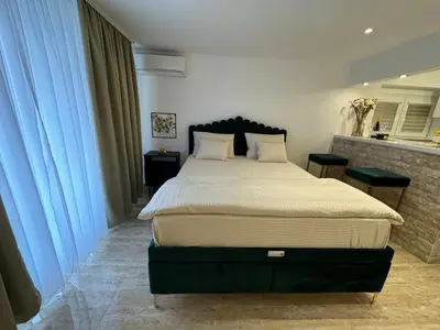 a bedroom with a large bed with white sheets at Apartman City Zeleznik in Belgrade