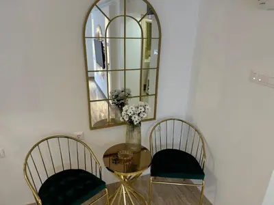 a table with two chairs and a mirror at Apartman City Zeleznik in Belgrade