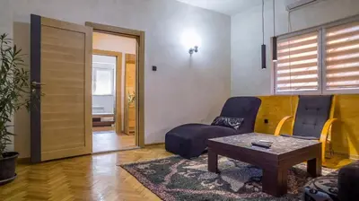 a living room with a couch and a table at Lukas Apartment in Belgrade