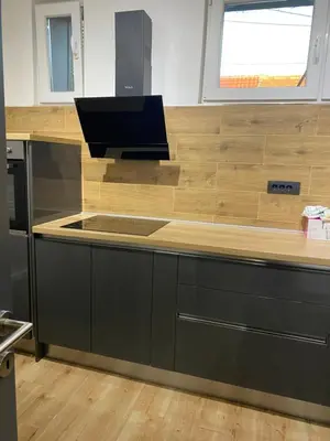 a kitchen with a wooden counter top with a sink at Lukas Apartment in Belgrade