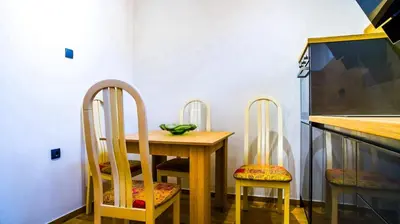 a dining room table with two chairs and a table at Lukas Apartment in Belgrade