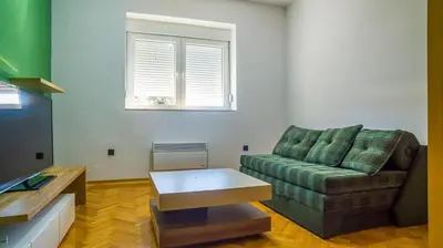 a living room with a couch and a coffee table at Lukas Apartment in Belgrade