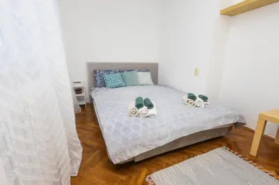 a bedroom with a bed with shoes on it at Apartment Sofia in Belgrade