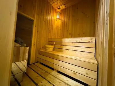 a wooden sauna with a bench in a cabin at Eden Spa Apartman in Arandjelovac