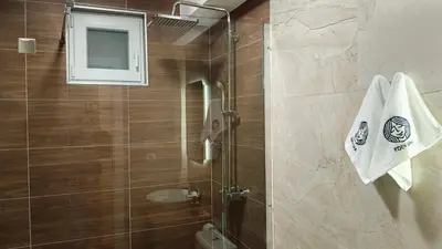 a bathroom with a shower with a glass door at Eden Spa Apartman in Arandjelovac