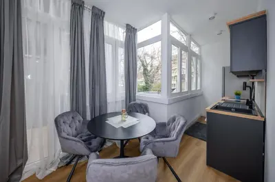 a living room with a table and chairs and a window at Top Central 6 Apartments in Belgrade